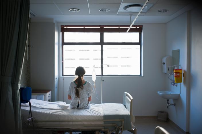 A woman sitting on a hospital bed