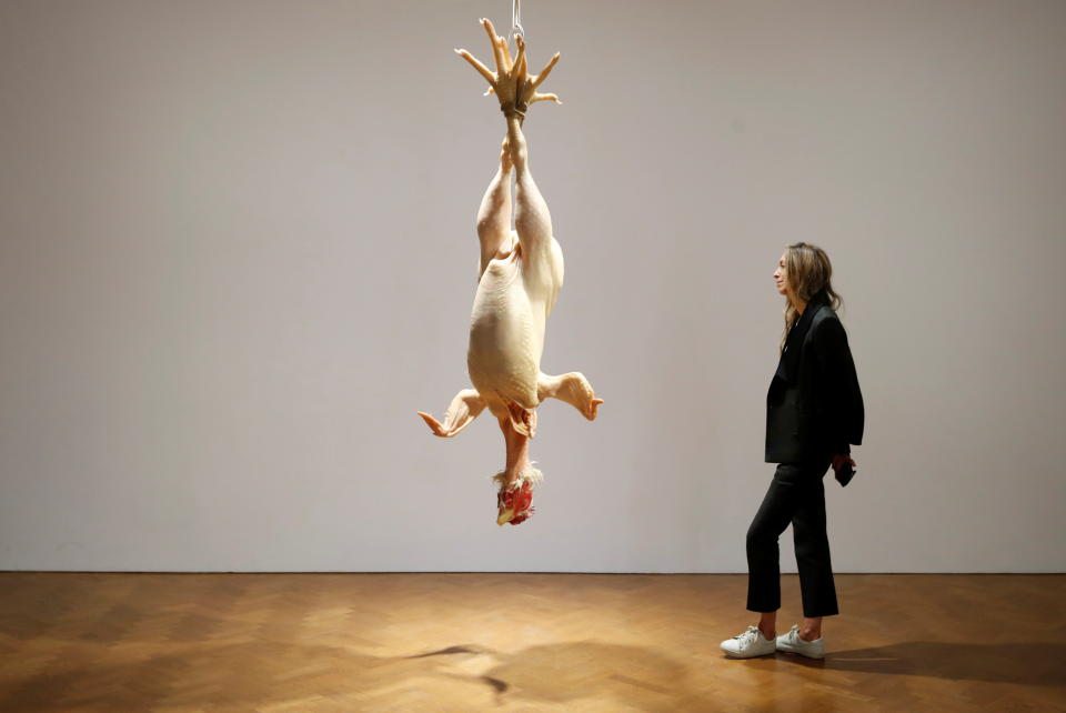 A gallery assistant poses by a sculpture entitled 'Still Life' by Australian artist Ron Mueck displayed at Thaddaeus Ropac gallery in London, Britain, October 11, 2021. REUTERS/Matthew Childs