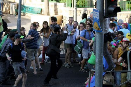 An Orthodox Jewish assailant (C) stabs participants at an annual gay pride parade, wounding six, in Jerusalem on Thursday, police and witnesses said July 30, 2015. REUTERS/Kobi Schutz