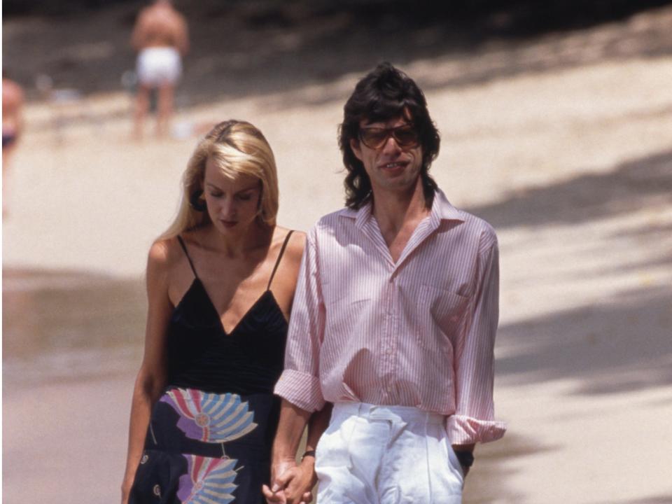 Mick Jagger and Jerry Hall on a beach in Mustique on February 18, 1987.