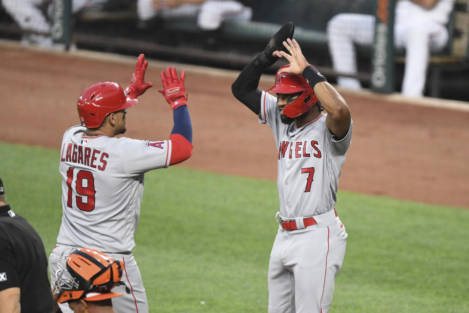 Los Angeles Angels' Juan Lagares (19) is greeted by Los Angeles Angels' fielder Jo Adell (7) after hitting a two-run home run Baltimore Orioles starting pitcher Spenser Watkins during the second inning of a baseball game Tuesday, Aug. 24, 2021, in Baltimore. (AP Photo/Terrance Williams)