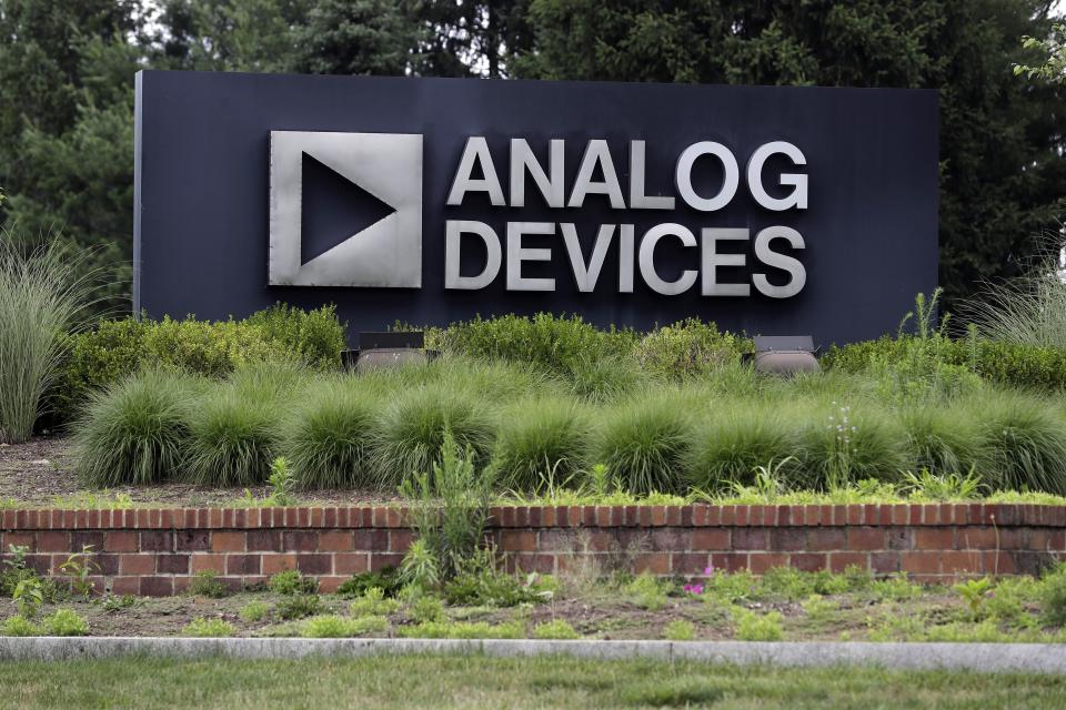 A sign points toward the headquarters of Analog Devices, Inc., Monday, July 13, 2020, in Norwood, Mass. Computer chip maker Analog Devices is buying Maxim Integrated in an all-stock deal that will create a company worth about $68 billion, and strengthens its position in the analog semiconductor sector. (AP Photo/Steven Senne)