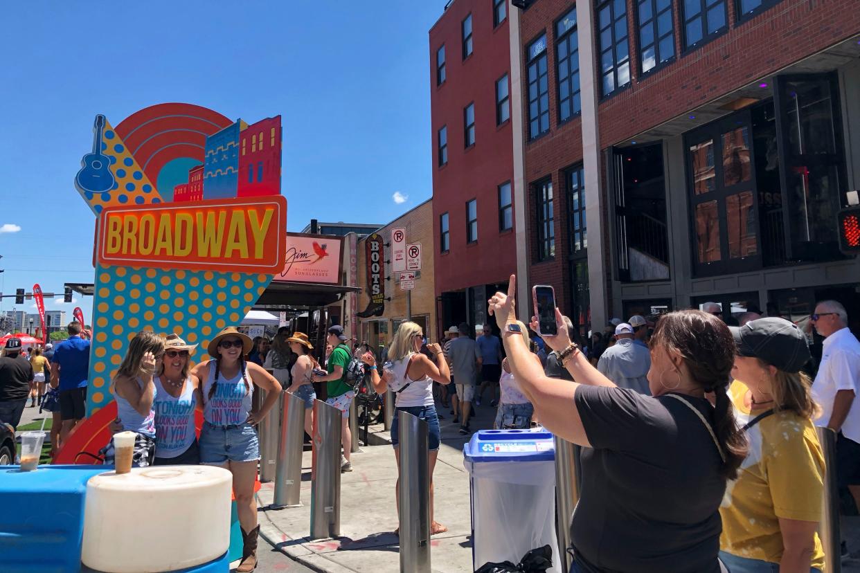 Country music fans make their way along Lower Broadway during CMA Fest in Nashville, Tenn., on Thursday, June 9, 2022.