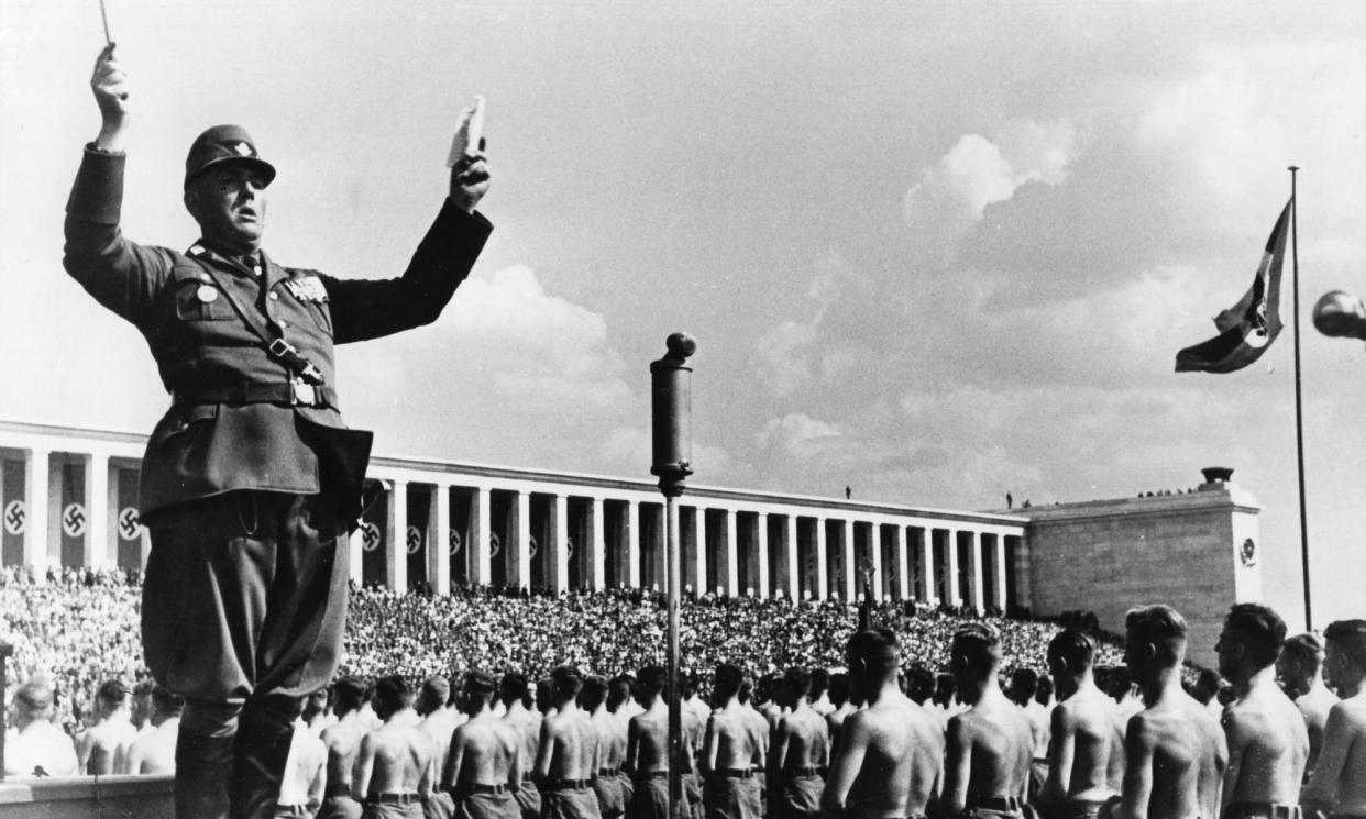 <span>Herms Niel conducting the marching band of the Reich Labour Service in 1937.</span><span>Photograph: ullstein bild/Getty Images</span>