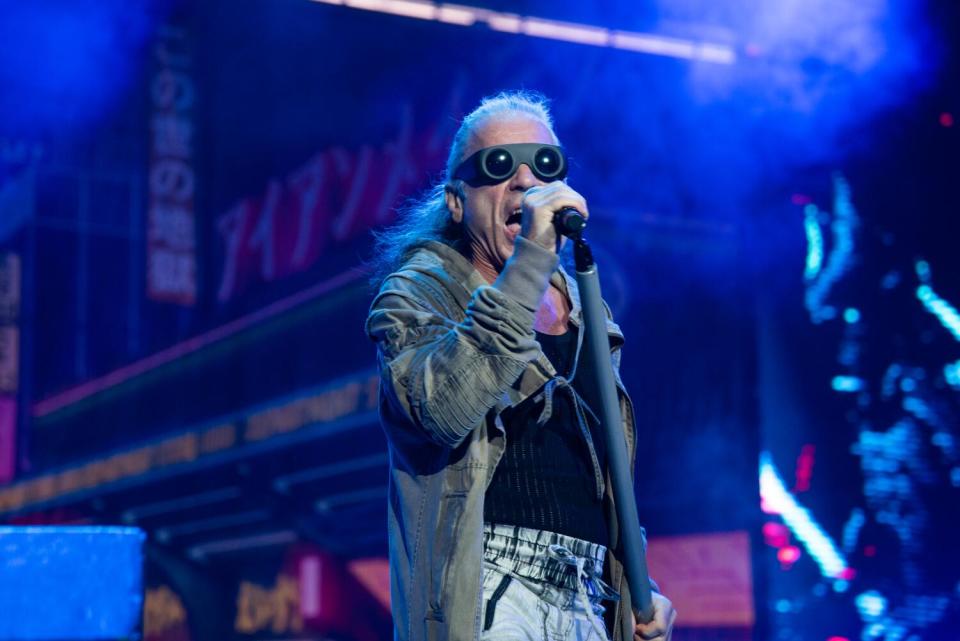 Bruce Dickinson of Iron Maiden performs on stage in glasses that resemble goggles.