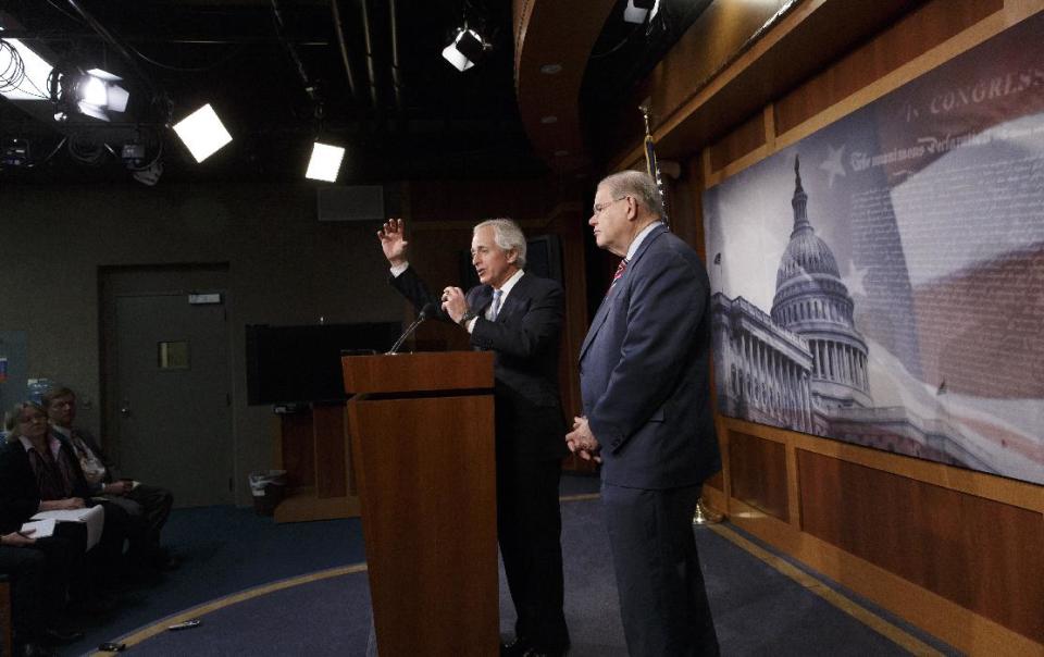 Senate Foreign Relations Committee Chairman Sen. Robert Menendez, D-N.J., right, and the committee's ranking member, Sen. Bob Corker, R-Tenn., participate in a news conference on Capitol Hill in Washington, Thursday, March 27, 2014, just after the Senate passed the Ukraine Aid Bill in a show of support for the people of Ukraine and a get-tough message for Russian President Vladimir Putin for taking over the Crimea region. (AP Photo/J. Scott Applewhite)