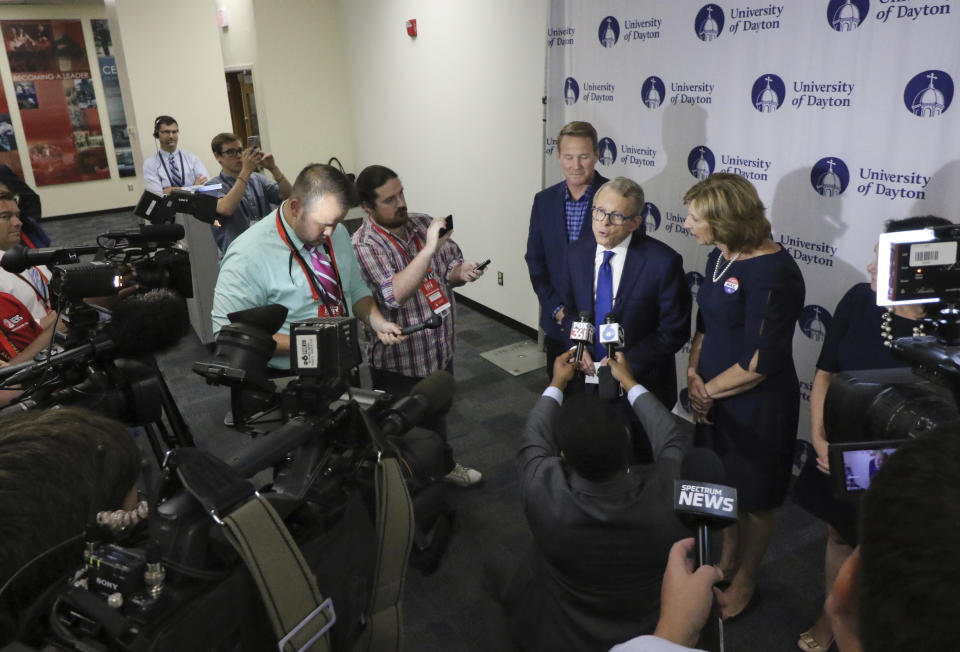 Ohio Attorney General and Republican gubernatorial candidate Mike DeWine, center, is photographed in the spin room following a debate against Ohio Democratic gubernatorial candidate Richard Cordray at the University of Dayton Wednesday, Sept. 19, 2018, in Dayton, Ohio. (AP Photo/Gary Landers)
