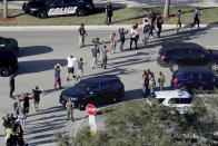 FILE - Students hold their hands in the air as they are evacuated by police from Marjory Stoneman Douglas High School in Parkland, Fla., on Feb. 14, 2018, after a shooter opened fire on the campus. Since 2012, a total of 73 students have been killed in school shootings with at least four victims shot and two victims killed, according to research by James Alan Fox, a criminologist at Northeastern University who studies mass killings. (Mike Stocker/South Florida Sun-Sentinel via AP, File)