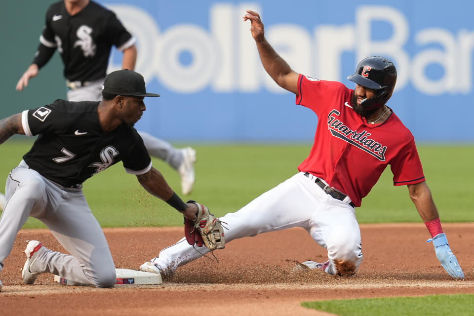 Cleveland Guardians' Amed Rosario, right, steals second base as Chicago White Sox shortstop Tim Anderson (7) reaches for a tag in the first inning of a baseball game Monday, May 22, 2023, in Cleveland. (AP Photo/Sue Ogrocki)