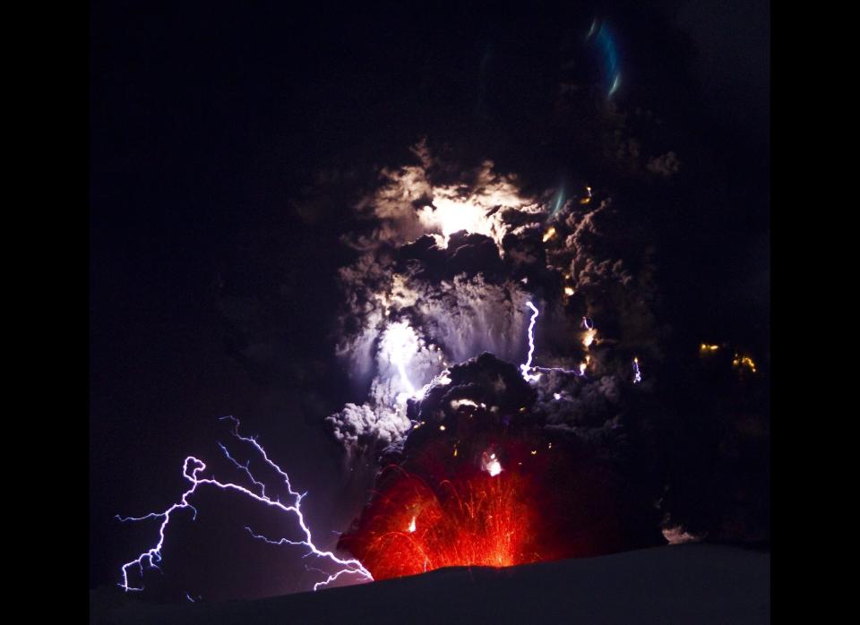 Lightning is seen within a cloud of volcanic matter as it rises from Eyjafjallajokull volcano April 18, 2010 Eyjafjallajokull, Iceland. A major eruption occurred on April 14 which resulted in a plume of volcanic ash being thrown into the atmosphere over parts of Northern Europe. Air traffic has been subject to cancellation or delays, as airspace across parts of Northern Europe has been closed. (Photo by Terje Sorgjerd/Getty Images)