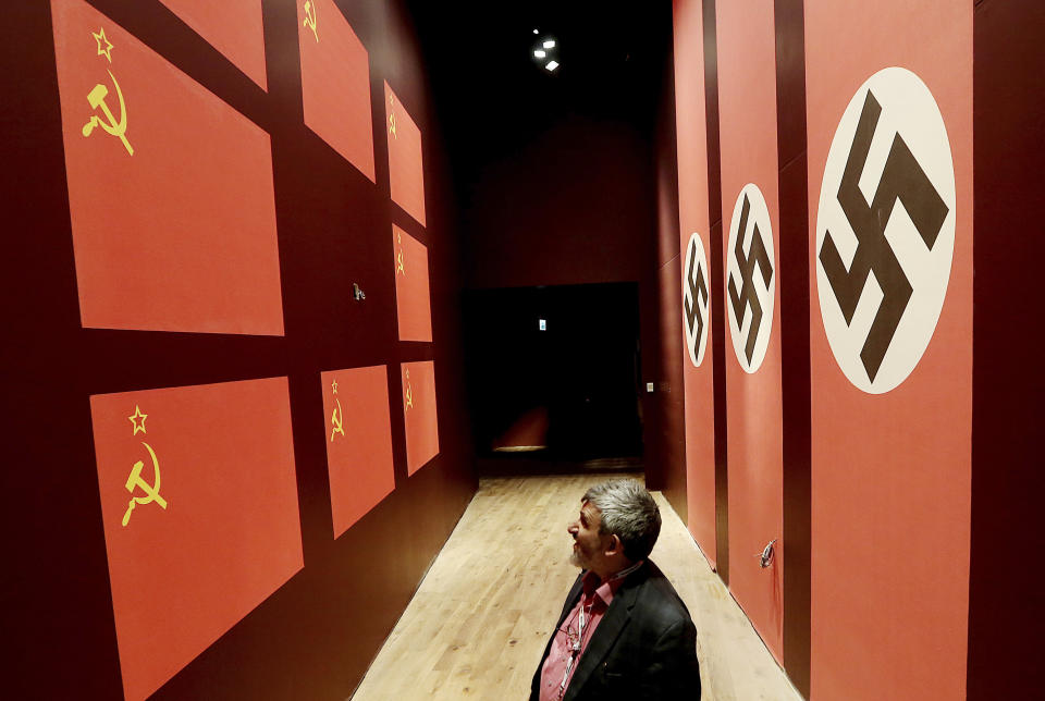 In this photo taken Jan. 23, 2017, a man visits the new Museum of the Second World War in Gdansk, Poland. The museum is at the center of a battle over history between its creators, who tell the history of the war by focusing on the suffering of different nations affected, and Poland's nationalist government, which seeks to take control of the museum to change its content to focus it on Polish suffering and military heroism. A court's decision this week has allowed the museum to exist independently for at least a few more weeks. (AP Photo/Czarek Sokolowski)