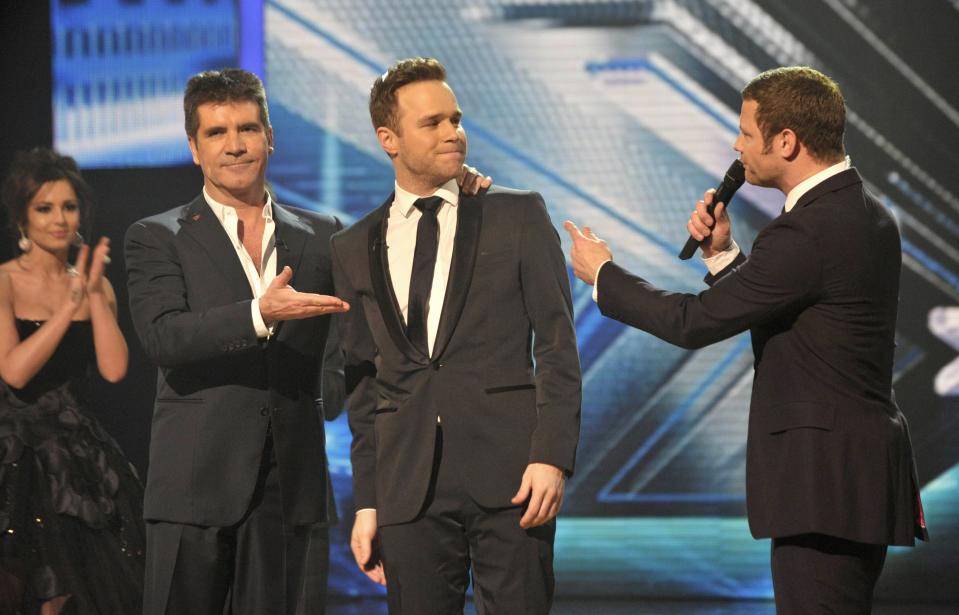 During the 2009 X Factor series, where Olly competed. (Credit: REX)