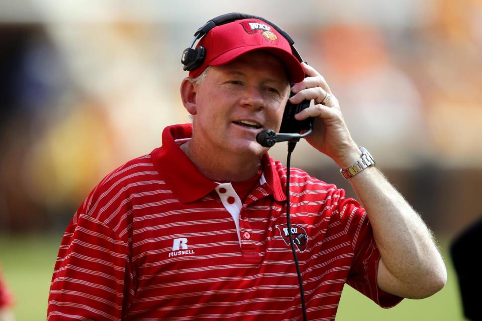 FILE - In this Sept. 7, 2013, file photo, Western Kentucky head coach Bobby Petrino looks to an official during an NCAA college football game against Tennessee in Knoxville, Tenn. A member of the Louisville board of trustees says Petrino has accepted an offer to be the Cardinals next head football coach. Jonathan Blue told The Associated Press on Wednesday evening, Jan. 8, 2014, that it is a "done deal." (AP Photo/Wade Payne, File)