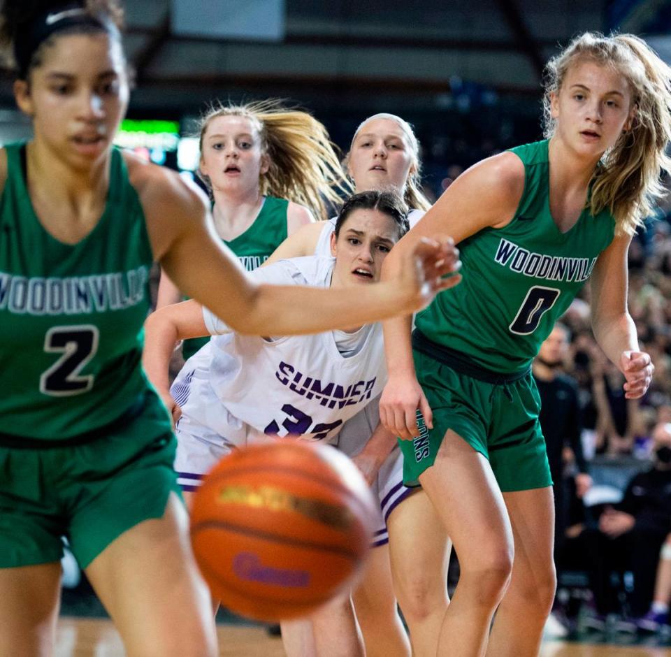 Sumner’s forward Alyson Deaver (33) watches as the ball flies out of her control towards Woodinville’s Veronica Sheffey (2) during the 4A state championship game at Tacoma Dome in Tacoma, Wash. on Saturday, March 5, 2022.