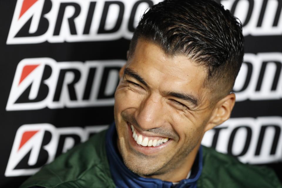 Luis Suarez of Uruguay's Nacional smiles in the dugout during a Copa Sudamericana quarter-final soccer match against Brazil's Goianiense at the Gran Parque Central stadium in Montevideo, Uruguay, Tuesday, Aug. 2, 2022. (AP Photo/Matilde Campodonico)