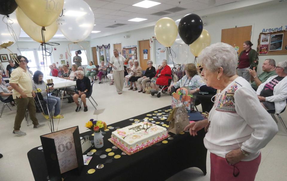 Elizabeth Parisi celebrates her 100th birthday, Wednesday, Oct. 11, 2023, with a room full of friends at the Adult Activity Center.