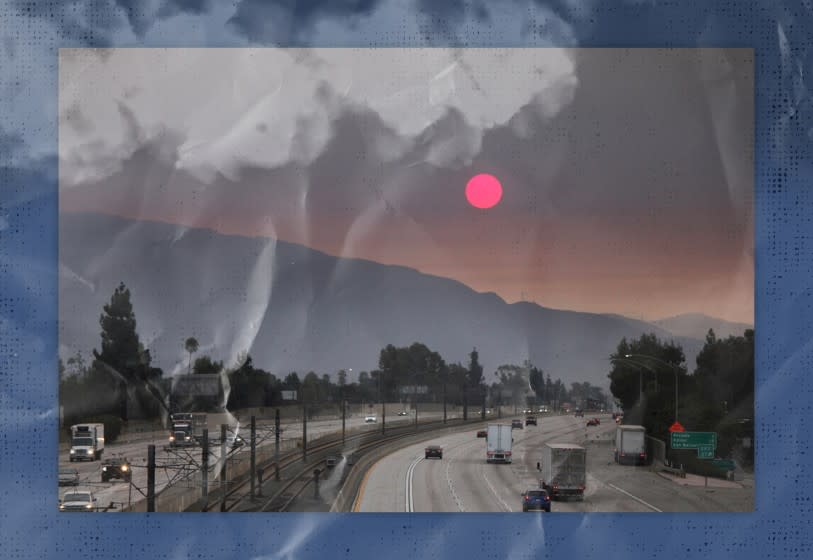 Smoke from wildfires darkens the sky over the mountains and freeway.