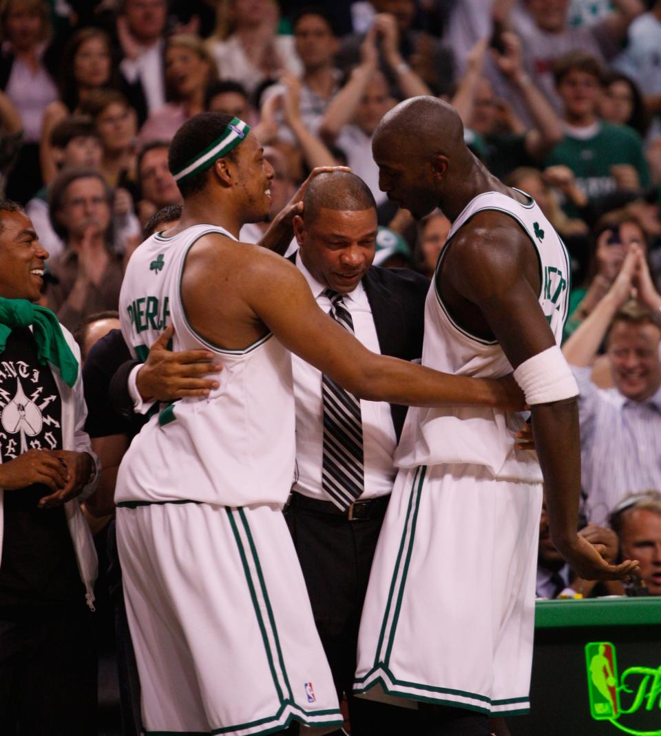 Boston Celtics' Paul Pierce, left, and Kevin Garnett, right, hug coach Doc Rivers during Game 6 of the NBA basketball final, June 17, 2008, in Boston.