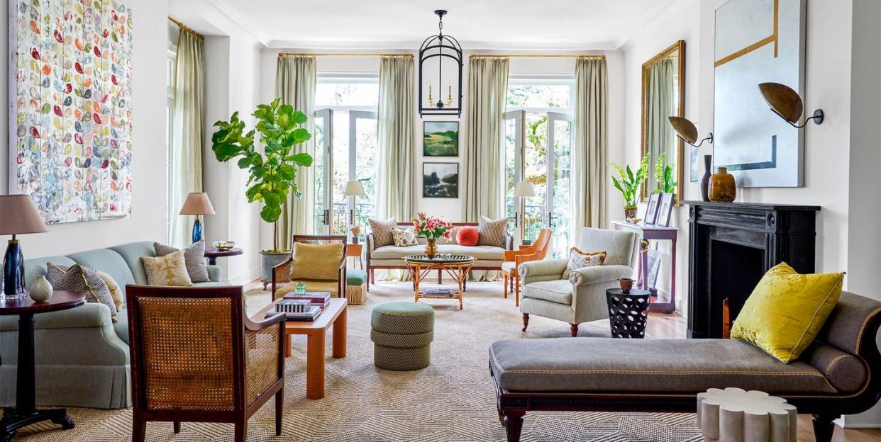 living room will tall floor to ceiling glass doors that open to outside garden and several seating  with settees and sofas and chairs and chaise longues in neutral colors