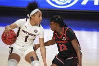 South Carolina guard Zia Cooke (1) dribbles next to Georgia guard Que Morrison (23) during the first half of an NCAA college basketball game Sunday, March 7, 2021, during the Southeastern Conference tournament final in Greenville, S.C. (AP Photo/Sean Rayford)