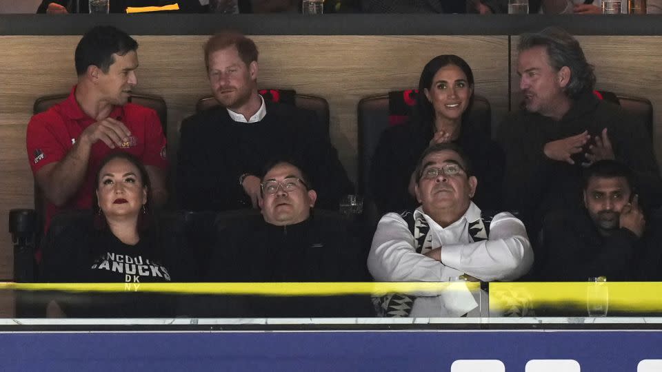 Prince Harry and Meghan Markle watch the game from a VIP box in Rodgers Arena. - Darryl Dyck/The Canadian Press/AP