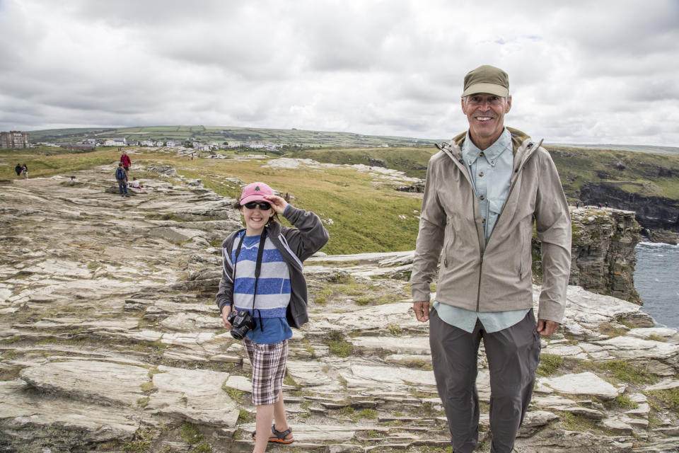 Grandfather and granddaughter walking around castle ruins