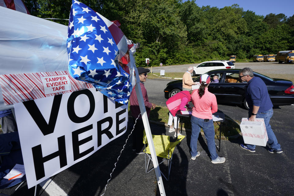 Convention workers collect ballots during a drive through GOP Convention vote in Chesterfield, Va., Saturday, May 8, 2021. (AP Photo/Steve Helber)