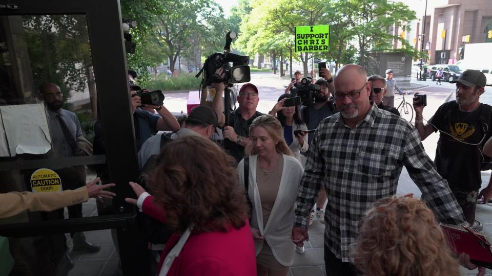 Chris Barber, third from right in plaid, walks into the Ottawa Courthouse Sept. 5, 2023, the day his trial began.