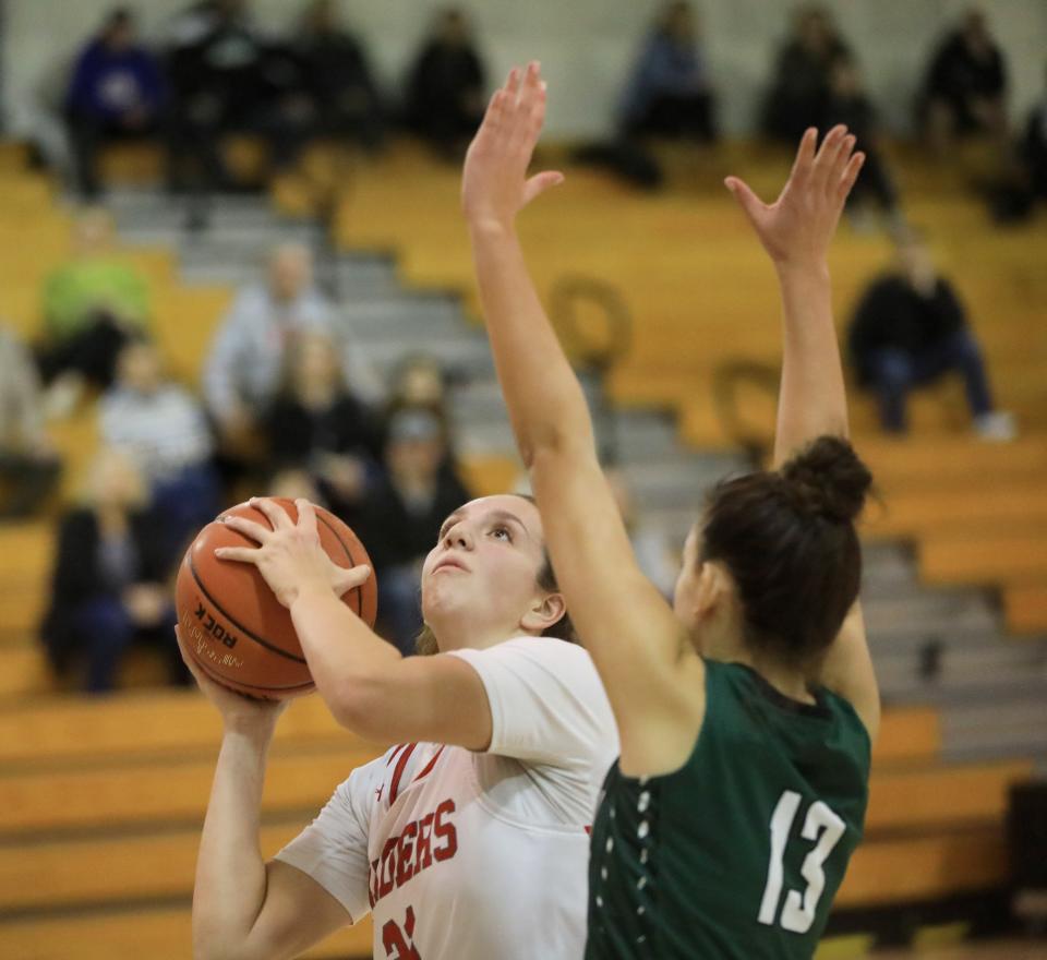 Red Hook's Emilie Kent takes a shot as Cornwall's Isabella Gallagher covers her during Thursday's game on December 14, 2023.