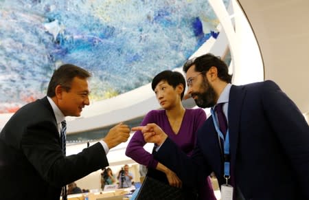 Hong Kong pro-democracy legislator Chan listens to Neuer Executive director of UN Watch and an unidentified delegate after her address to a session of the Human Rights Council at the United Nations in Geneva