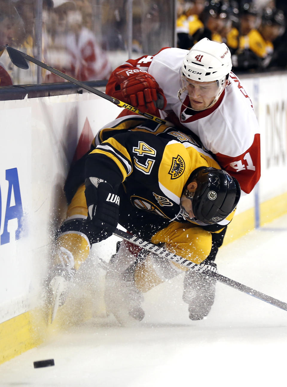 Boston Bruins defenseman Torey Krug (47) stops Detroit Red Wings' Luke Glendening (41) from getting around him during the first period of Game 2 of a first-round NHL hockey playoff series in Boston, Sunday, April 20, 2014. (AP Photo/Winslow Townson)