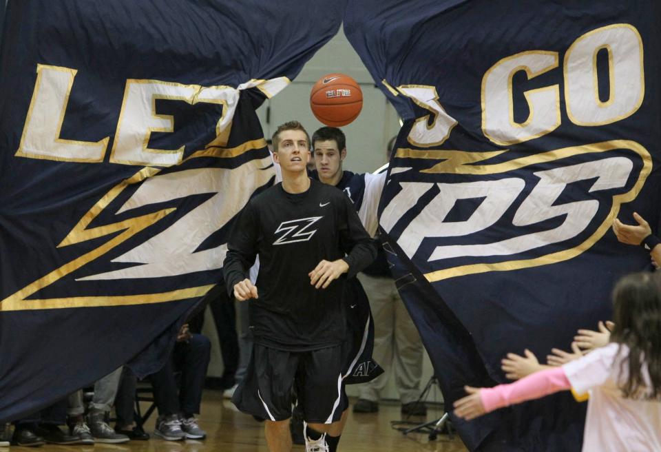 Akron's Brian Walsh (left) is followed by teammate Jake Kretzer as the team heads out to the court before playing Kent State at Rhodes Arena on Friday, Mar. 8, 2013.
