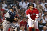 Boston Red Sox's Enrique Hernandez, right, watches his sacrifice fly in front of New York Yankees' Gary Sanchez that scored Xander Bogaerts during the second inning of a baseball game, Saturday, June 26, 2021, in Boston. (AP Photo/Michael Dwyer)