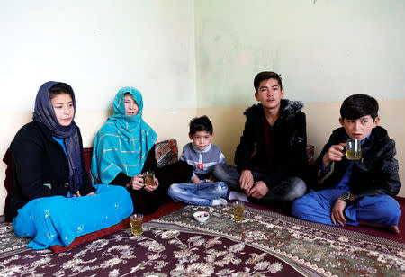 Murtaza Ahmadi, 7, (C) an Afghan Lionel Messi fan, sits with his family at their house in Kabul, Afghanistan December 8, 2018. REUTERS/Mohammad Ismail