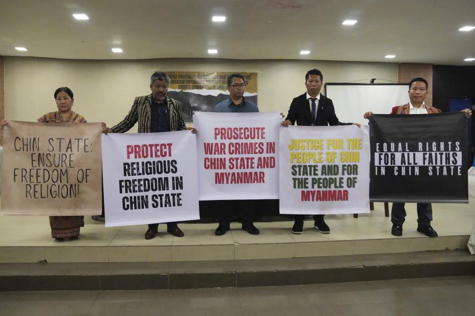 Burmese relatives of victims of deadly attacks by their government's military hold slogans after filing a criminal complaint against Myanmar's top generals at the Department of Justice in Manila, Philippines on Wednesday Oct. 25, 2023. Relatives of victims of alleged war crimes committed by Myanmar’s military filed a criminal complaint in the Philippines against their nation’s ruling generals in a desperate attempt to test whether such a case could succeed outside the violence-wracked country.(AP Photo/Aaron Favila)