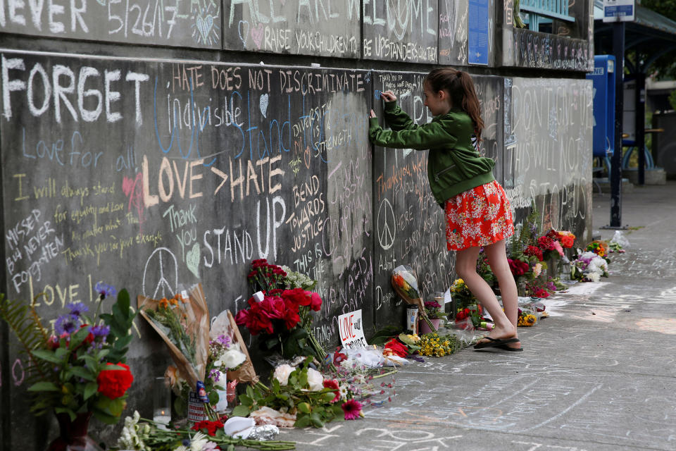 <p>A girl leaves a message at a makeshift memorial for two men who were killed on a commuter train while trying to stop another man from harassing two young women who appeared to be Muslim, in Portland, Ore., May 29, 2017. (Terray Sylvester/Reuters) </p>