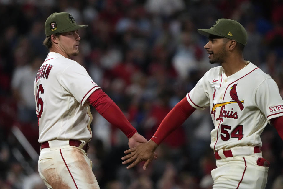 St. Louis Cardinals' Nolan Gorman, left, and Oscar Mercado celebrate a 6-5 victory over the Los Angeles Dodgers in a baseball game Saturday, May 20, 2023, in St. Louis. (AP Photo/Jeff Roberson)