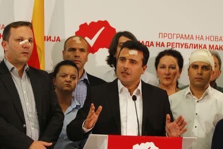 Macedonian Social Democratic leader Zoran Zaev (C) and members of his party attend a news conference in Skopje, Macedonia, April 28, 2017. REUTERS/Ognen Teofilovski