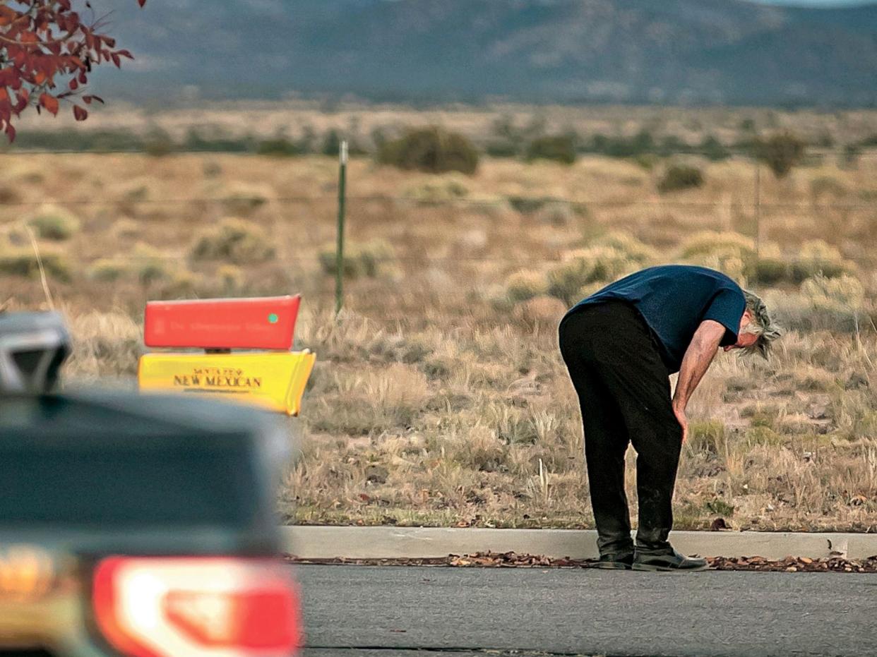 A distraught Alec Baldwin lingers in the parking lot outside the Santa Fe County Sheriff's Office in Santa Fe, N.M., on Oct. 21, 2021.