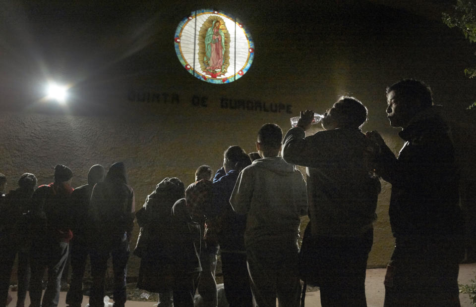 FILE - In this Dec. 11, 2018 file photo, asylum-seekers arrive from an immigration detention center to a shelter in San Diego, Calif. The state of California is freeing up to $28 million to help asylum-seekers released in the U.S. with notices to appear in court with hotels, medical screenings, and transportation. California's generosity is a stark contrast to Arizona and Texas, where border state officials have challenged and sharply criticized President Joe Biden's immigration policies. (AP Photo/Gregory Bull, File)