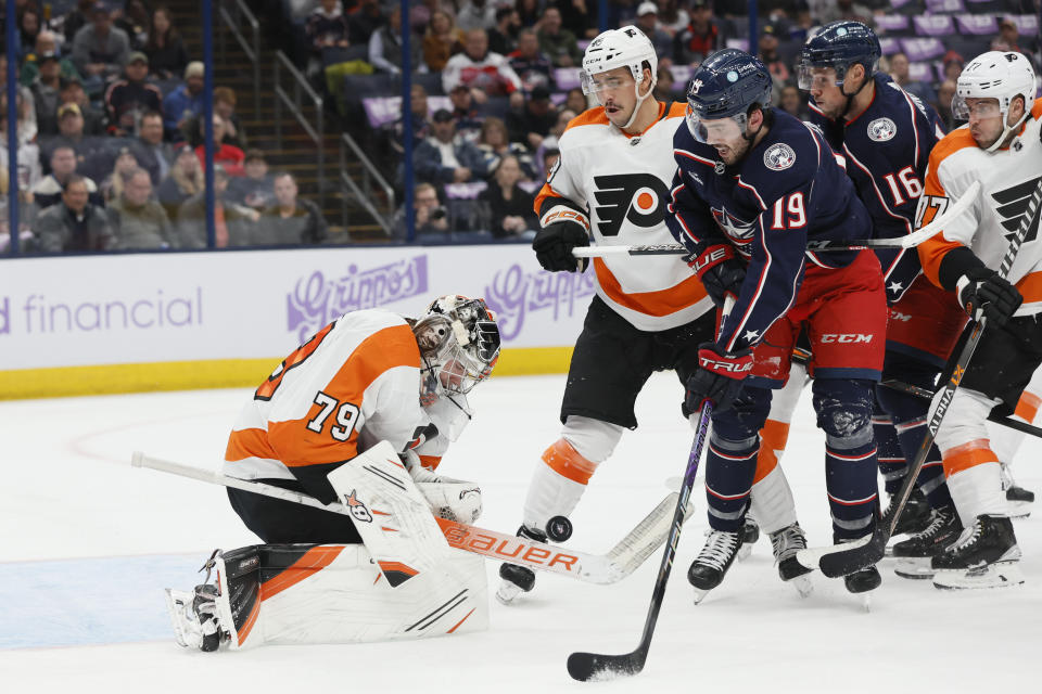 Philadelphia Flyers' Carter Hart, left, makes a save against Columbus Blue Jackets' Liam Foudy during the second period of an NHL hockey game Tuesday, Nov. 15, 2022, in Columbus, Ohio. (AP Photo/Jay LaPrete)