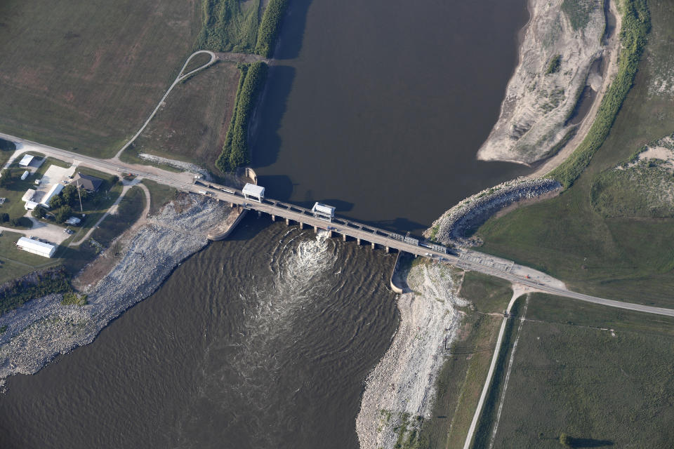 FILE - This Aug. 2, 2018, file photo shows the Old River Control Structure, a floodgate system which regulates the flow of water leaving the Mississippi River into the Atchafalaya River, in Vidalia, La. The state of Mississippi is suing the federal government for at least $25 million, claiming a federal dam complex in Louisiana that keeps the Mississippi River from changing course is harming state land. The suit was filed Monday in the Court of Federal Claims by Mississippi officials on behalf of three school districts. (AP Photo/Gerald Herbert, File)