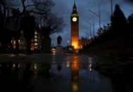 The Houses of Parliament are reflected in a puddle as they are illuminated in London, Britain November 30, 2015. REUTERS/Neil Hall