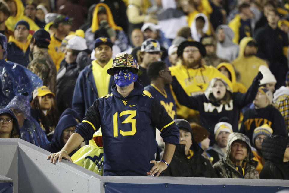 West Virginia fans look on as their side goes down by two touchdowns during the second half of an NCAA college football game against Oklahoma State, Saturday, Oct. 21, 2023, in Morgantown, W.Va. (AP Photo/Chris Jackson)