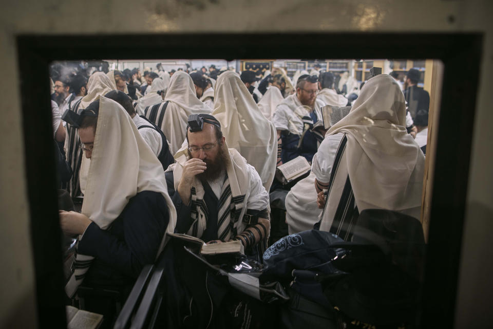 FILE - Chabad-Lubavitch rabbis gather to pray for Israel as well as Jews everywhere at the resting place of the Rebbe, Rabbi Menachem Mendel Schneerson at Montefiore Cemetery on Friday, Nov. 10, 2023, in the Queens borough of New York. (AP Photo/Andres Kudacki, File)