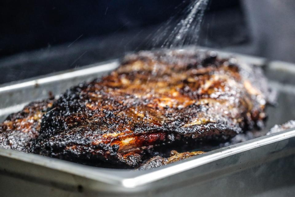 Dwayne Gibson Sr. puts rib tips on the smoker on Saturday, Jan. 1, 2022 at Gip Got Tips, 2073 North Emerson Ave. Indianapolis Ind. 