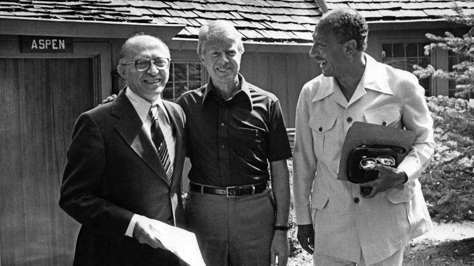 Portrait of from left, Israeli Prime Minister Menachem Begin (1913 - 1992), US President Jimmy Carter, and Egyptian President  Anwar Al Sadat (1918 - 1981) as they pose together during the Egyptian-Israeli peace negotiations, in front of Aspen Lodge at Camp David, near Thurmont, Maryland, September 12, 1978. The negotiations resulted in the 'Camp David Accords' which were formalized as the 'Egypt--Israel Peace Treaty' the following year, in Washington DC on March 26, 1979. (Photo by White House via CNP/Getty Images) - The White House/CNP/Getty Images