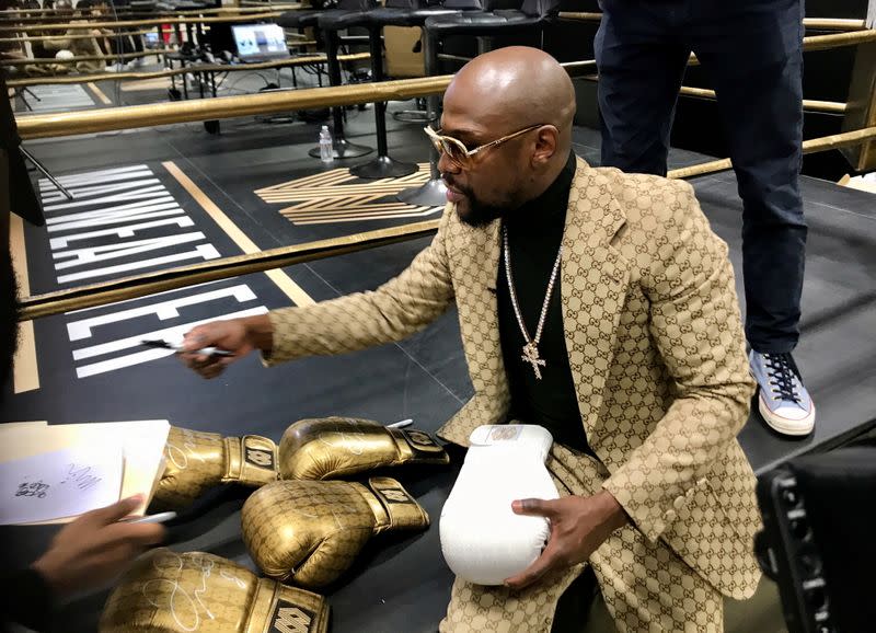 FILE PHOTO: Floyd Mayweather signs gloves at the opening of the Mayweather Boxing + Fitness gym in Torrance