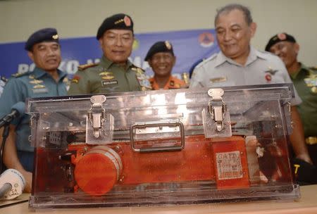 Tatang Kurniadi (R), head of the National Transportation Safety Committee, and Indonesian Armed Forces Chief Moeldoko (2nd L) present the flight data recorder from AirAsia QZ8501 to the media at the airbase in Pangkalan Bun, Central Kalimantan January 12, 2015, in this photo taken by Antara Foto. REUTERS/Antara Foto/Prasetyo Utomo