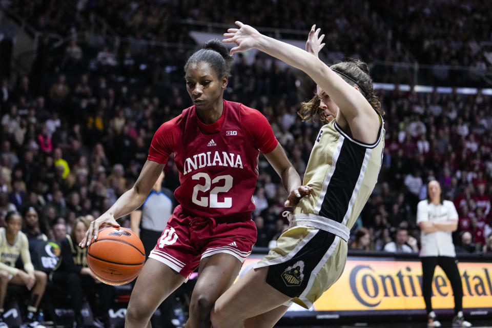 Purdue guard Cassidy Hardin (5) draws the offensive foul from Indiana guard Chloe Moore-McNeil (22) in the first half of an NCAA college basketball game in West Lafayette, Ind., Sunday, Feb. 5, 2023. (AP Photo/Michael Conroy)